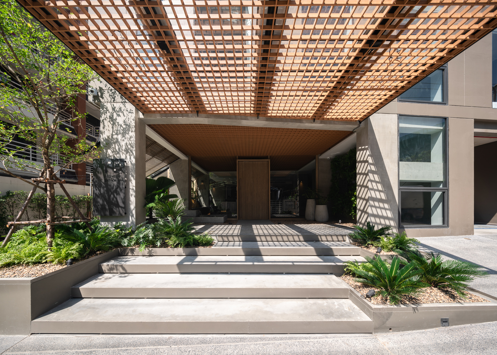 NORMA Hotel Sathorn entrance with wooden lattice canopy